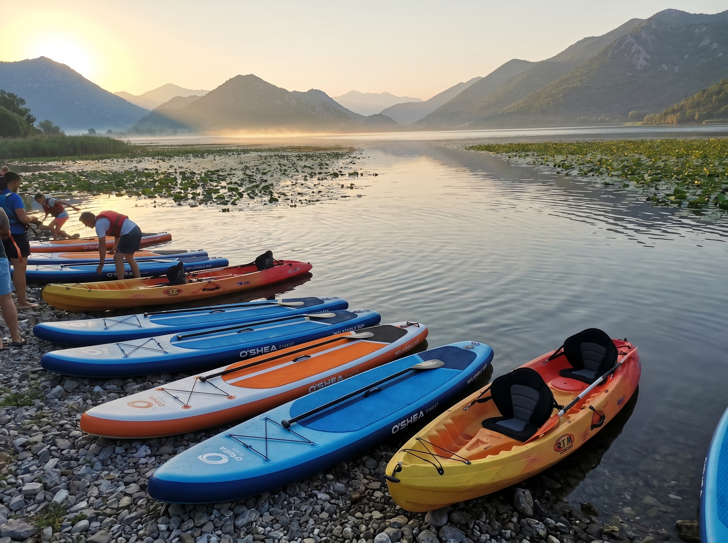 SUP boards and kayaks lined up at sunrise on Lake Skadar